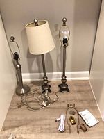 Three lamps, shade, extra wiring parts displayed