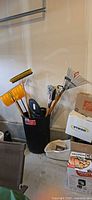 Overall lot: Rubbermaid can holding assorted yard tools
