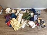 Full lot overview of textiles and hardware spread on floor