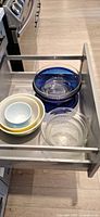 Drawer view showing all glass and ceramic bowls