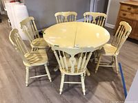 Dining table with six chairs arranged around it