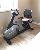 Full view of Sportop recumbent exercise bike showing console, seat, pedals and frame