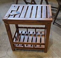 Full view of slatted side table showing top and lower shelf