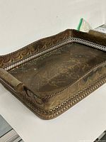 Overall view of brass tray showing pierced sides and etching