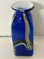 Front of blue Murano glass vase with swirl pattern