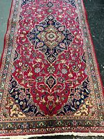 Full length view of Kashan rug showing border and central field