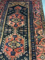 Full section of rug showing central medallion and border colors