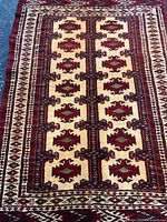 Full view of Persian Baluchistan wool rug showing entire field and borders