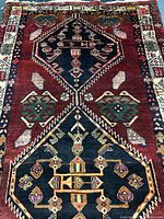 Full view of handmade Persian wool rug showing overall pattern and colours