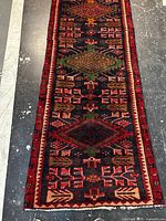 Full view of Persian wool runner showing entire length and pattern