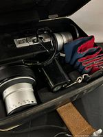 Camera, case interior, filters and grip visible