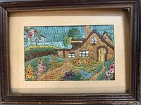 Overall view of framed needlework artwork in wooden frame