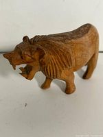 Left-front perspective of carved wooden lion