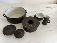 All pieces grouped: casserole, stand, creamer, sugar bowl, two lids
