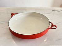 Top view showing white enamel interior and red handles