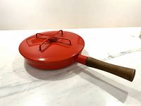 Pan with lid, red exterior, wood handle