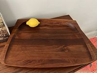Top view of teak platter with lemon for scale