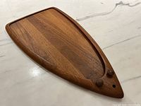 Front view of teak platter showing recessed area and overall shape