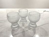Three Iittala Kekkerit beer glasses on marble surface