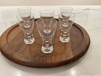 Six Iittala shot glasses on wooden tray