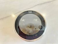 Front view of Nest thermostat display