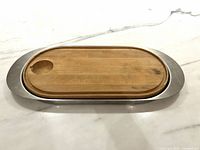 Tray fitted with cutting board, board side showing recess