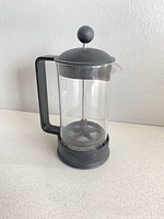 Full view of Bodum glass French press with black frame and lid