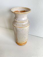 Full view of speckled ceramic vase showing shape, glaze, and size