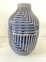 Front view of blue glazed ceramic vase with raised geometric pattern