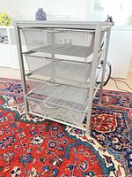 Overall view of metal frame with four mesh drawers