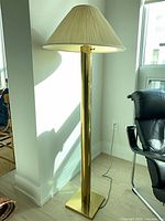 Full view of gold floor lamp with shade