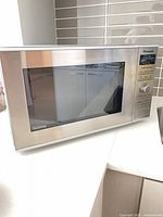 Front view of stainless Panasonic Inverter microwave showing door and control panel