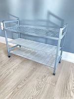 Full view of silver three-tier metal shoe rack