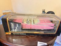 Boxed Maisto Special Edition pink Cadillac model car side view