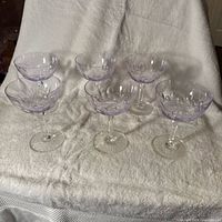 Group of six Alexandrite coupe stems on cloth backdrop