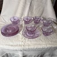 Set of six cups and stack of saucers showing lavender hue