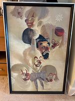 Full view of framed clown print showing six clown faces and black frame