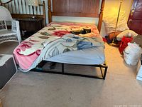 Bed made up, showing black metal frame edges and mattress