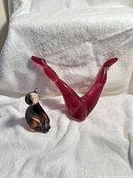 Front view of both Murano glass pieces: cat and legs sculpture