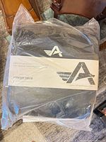 Factory-sealed Athlos Fitness abdominal exercise mat in packaging with branding visible