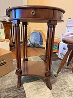 Full view of wood side table front with drawer and shelf