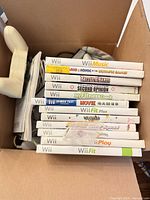 Stack of Wii game cases showing titles and quantity