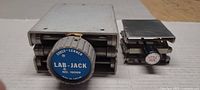 Front view of both jacks showing size difference and knob labels