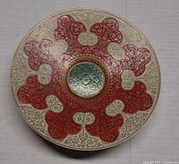Top view of enameled brass pedestal plate showing decorative pattern