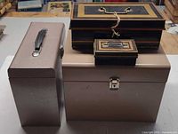 Group shot of four metal boxes showing relative sizes and colors