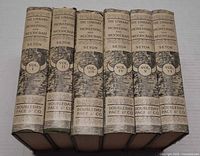 Spine view of six volumes I–VI showing series title, volume numbers and publisher