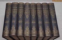 Spine view of all eight volumes showing gilt titles and numbering
