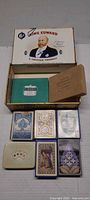 Open King Edward cigar box showing multiple playing card decks inside