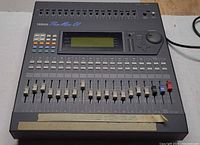 Full top view of Yamaha ProMix 01 mixer showing faders, buttons, display