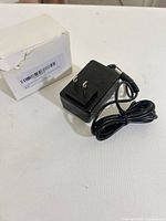 adapter with attached cable and white box